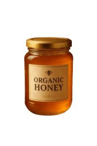 Premium glass jar of organic honey with golden lid, fresh honeycomb, chamomile flowers, and bees in natural studio lighting.