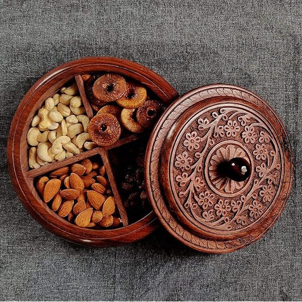 Handcrafted wooden dry fruit box with carved floral lid, filled with cashews, almonds, figs, and raisins.